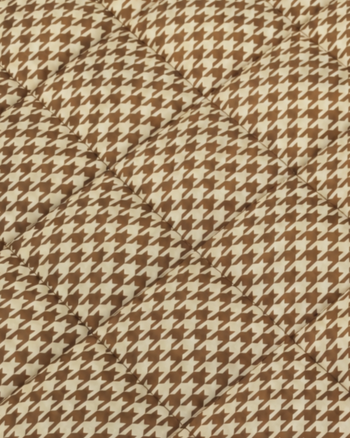Close-up of the Biscuit picnic blanket's quilted terracotta and cream houndstooth