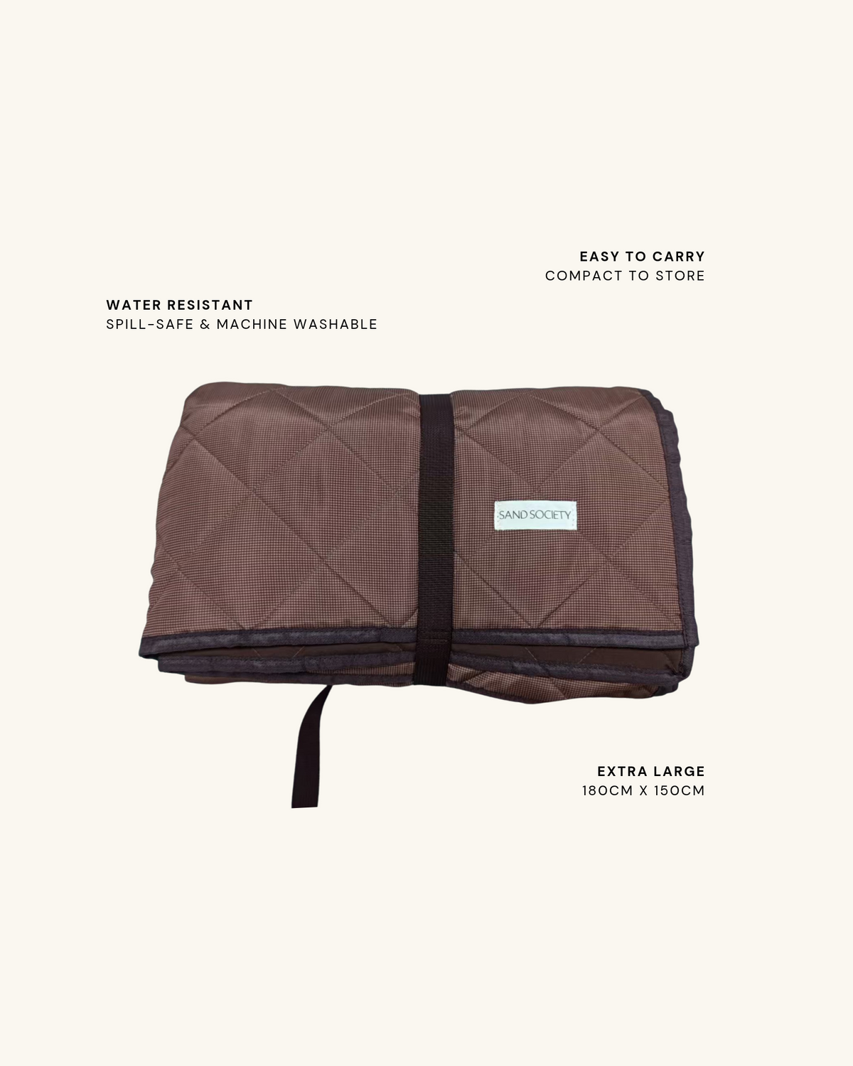 Chocolate gingham picnic blanket folded with its carry strap. Water resistant: spill-safe and machine washable. Easy to carry: compact to store. Extra large: 180 x 150cm